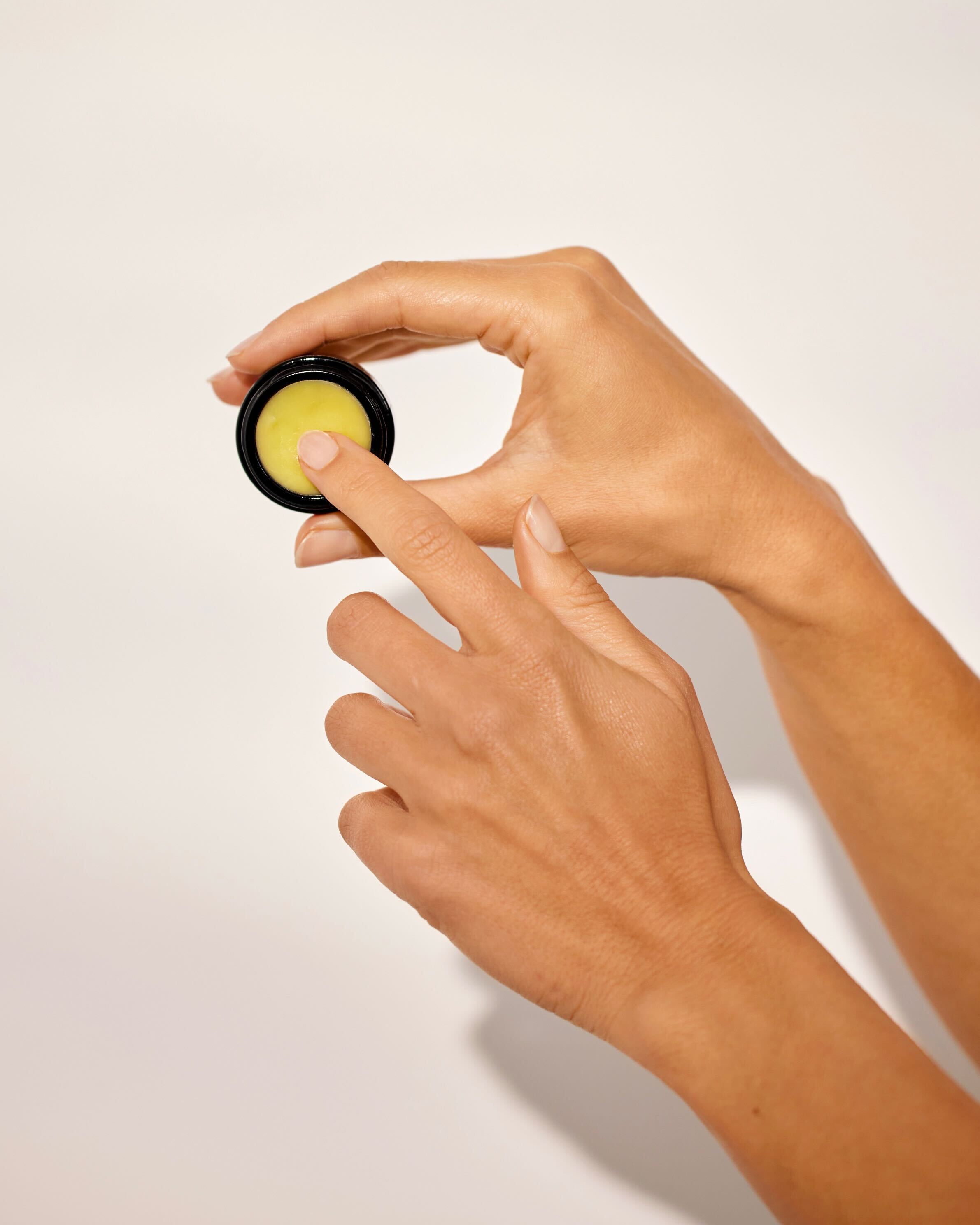 hands holding a lip balm