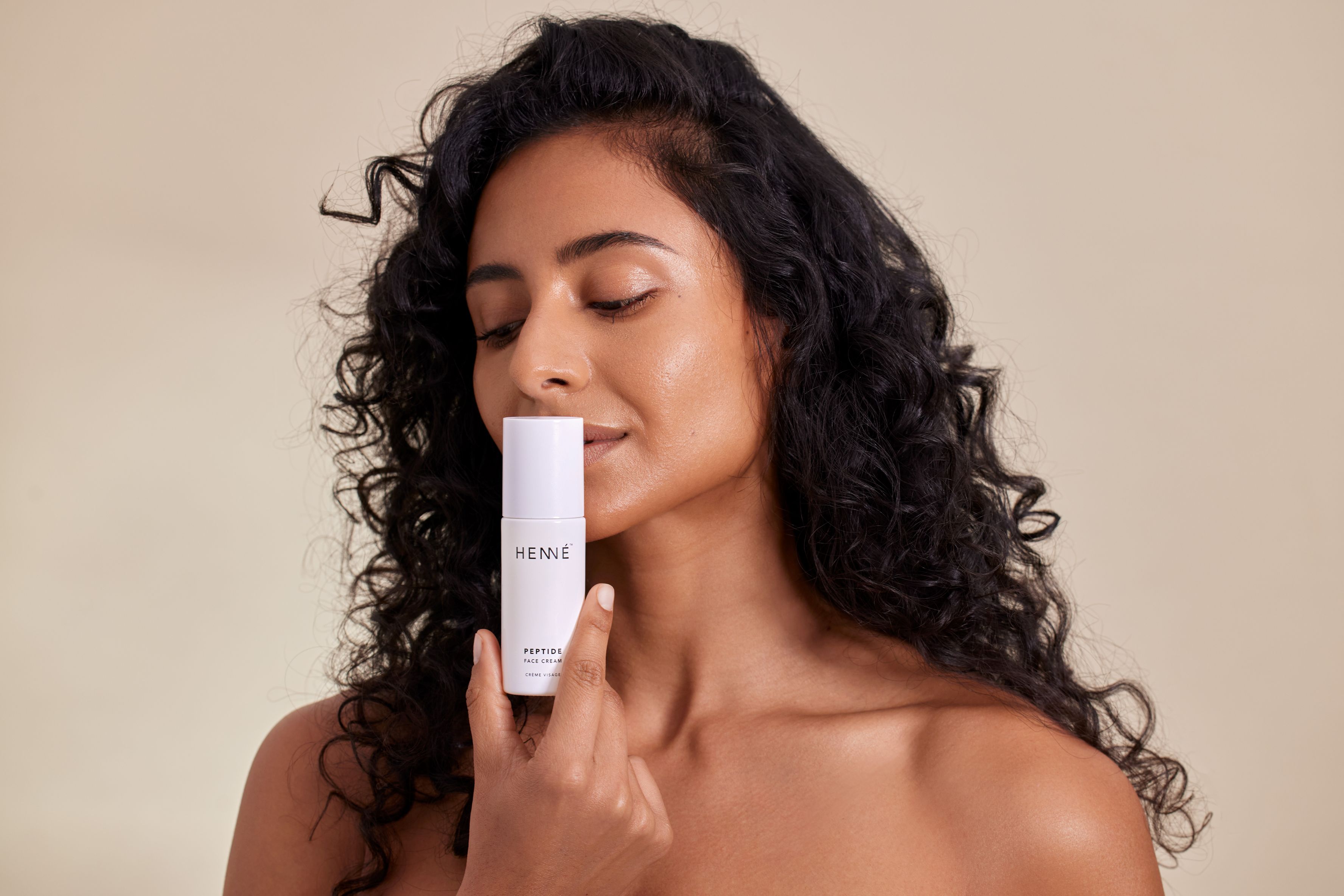 woman holding a face cream bottle